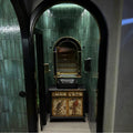 Lisbon Green Jade Shine green gloss brick tiles in a styled interior