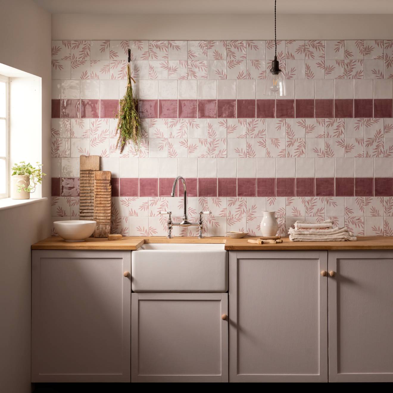 Kitchen with floral tile backsplash and wooden countertop