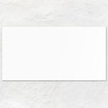 A plain white rectangular ice white rectified ceramic cardstock sheet measuring 60x30 centimeters