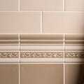Close-up of beige tiles with decorative border