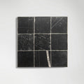 Detail of natural veining across Sahara Noir marble tiles