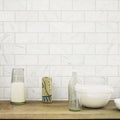Malmo Base White Rectangle white tiles with a clear glass green-based pitcher