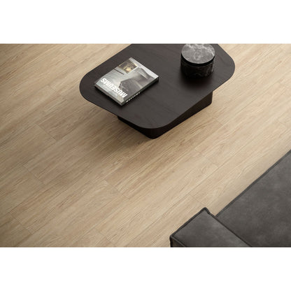 Black coffee table with a magazine and decorative item on a wooden floor in Minoli Bowland Oak Wood Effect Porcelain Tile (22.5x90cm) 