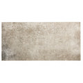 A rectangular Montpellier Portes tile 60 x 30cm with a textured mottled gray and beige finish resembling aged concrete