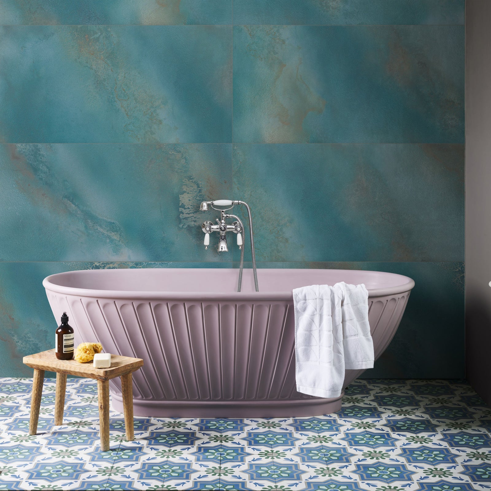 Maldives Porcelain Lagoon teal porcelain tiles with a lavender freestanding bathtub