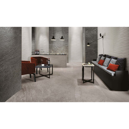 Modern interior with gray tiles, a sofa, and red cushions.