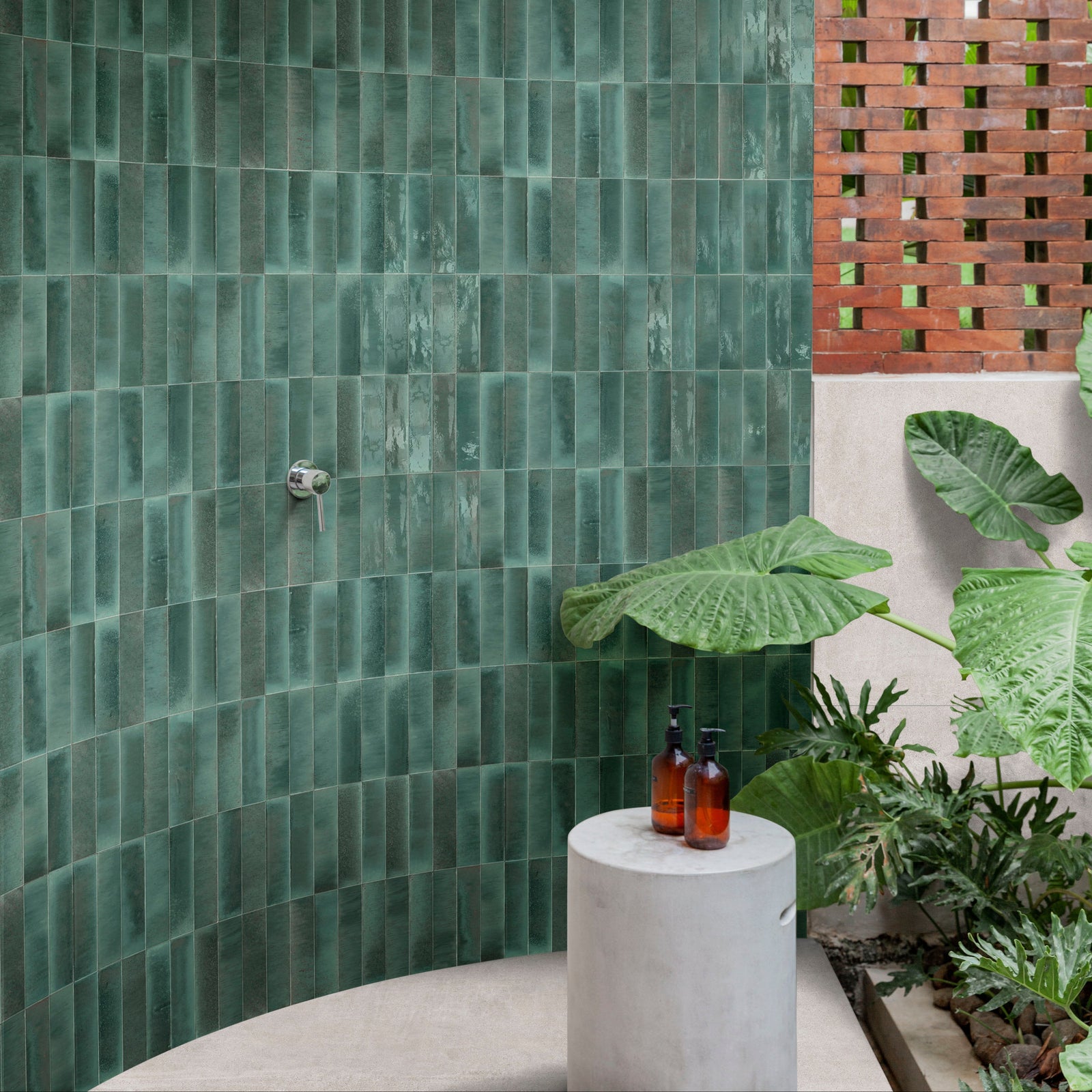 Emerald green rectangular luminous lume turquoise tiles with subtle textured finish covering a curved wall