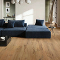 Modern living room with a blue sectional sofa and wooden floor.