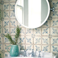 A teal ceramic pitcher with a textured surface and handle holding fresh rosemary for paris isabelle patterned terracotta tile decor