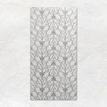 Palazzo Filigrana 60x30cm translucent white ceramic tile with a grey floral scrollwork pattern