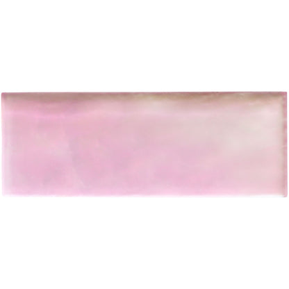 A rectangular pink frost brick radiance ceramic tile with a glossy finish and subtle gradient glow