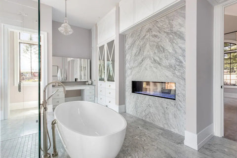 A man and woman crouching beside white porcelain tile samples in a showroom for top design ideas.