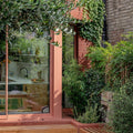 A sleek peach-colored sliding glass door with a modern frame and clean lines for quarry red square tile settings
