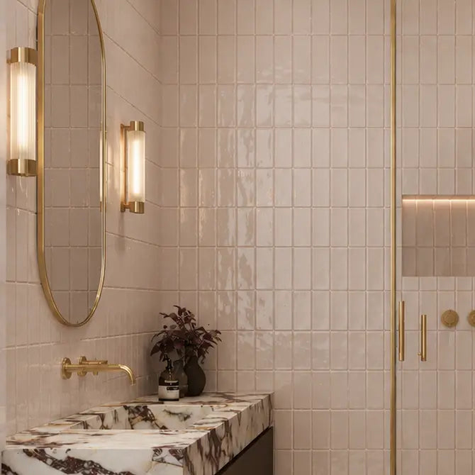 Remy Blush pink gloss brick wall tile 6.5 x 13cm shown in a room setting