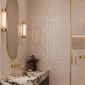 Remy Blush pink gloss brick wall tile 6.5 x 13cm shown in a room setting