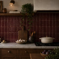 Remy Wine red gloss brick wall tile 6.5 x 13cm shown in a room setting