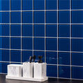Rhine Clear Glass 100 x 100mm royal blue glass tile with a bathroom organiser and soap dispenser