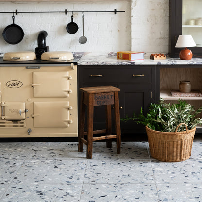 Rialto Terrazzo Castello Honed grey terrazzo tiles with a wood-burning stove