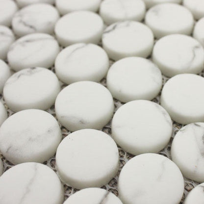 White circular marble mosaic tiles with subtle gray veining from the ritz statuario round mosaic collection