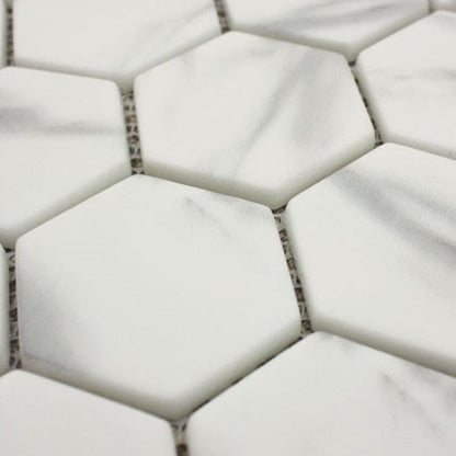 White hexagonal marble mosaic tiles with subtle gray veining ritz carrara hexagon mosaic for elegant surfaces
