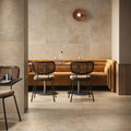 Modern restaurant interior with brown chairs and a beige wall.