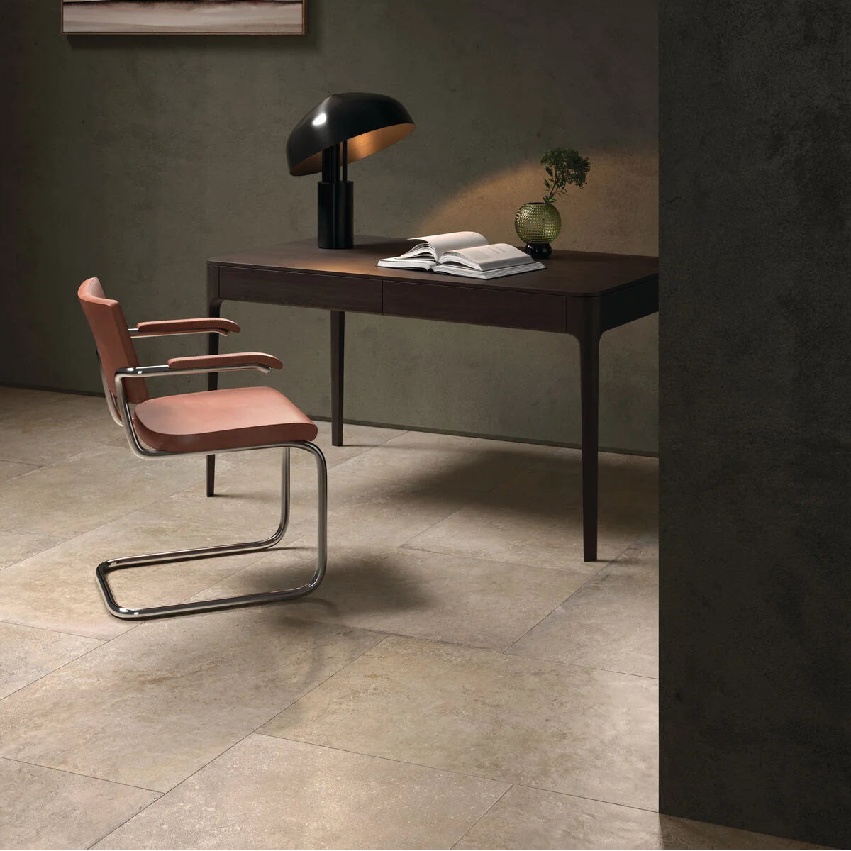 Modern office setup with a desk, chair, and lamp in a minimalistic room.