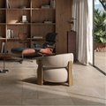 Modern interior with wooden bookshelf, chair, and table in a well-lit room.