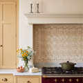 STUDIO Sanderson Anaar Ochre ceramic tiles with matching border and corner pieces framing a panel