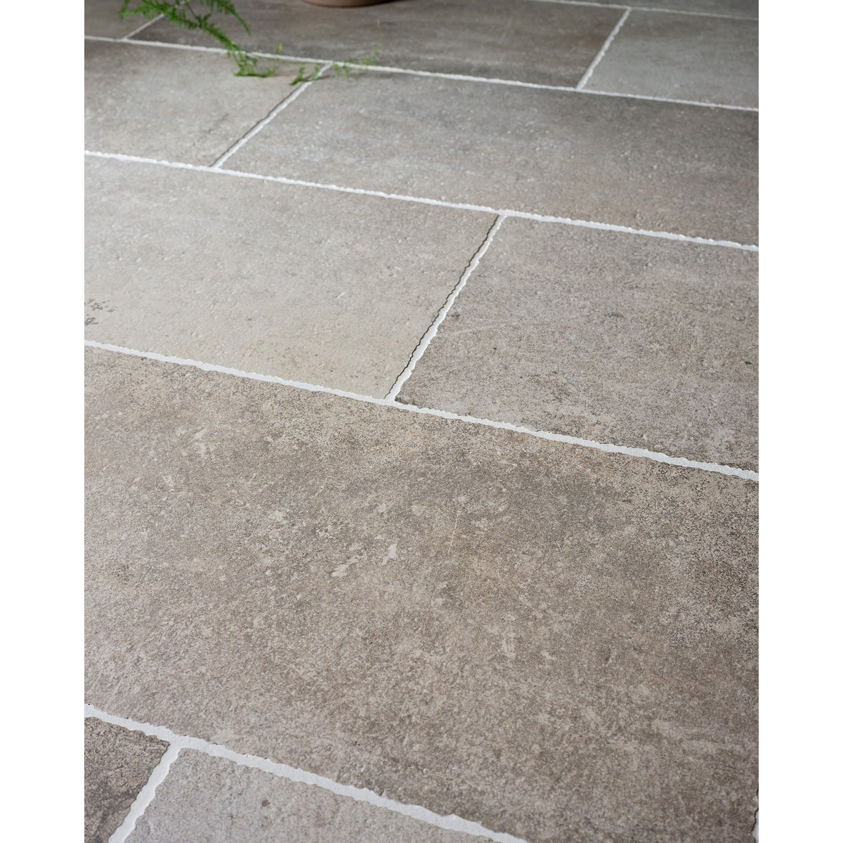 Wetherby Porcelain aged flagstone-effect floor in a room setting