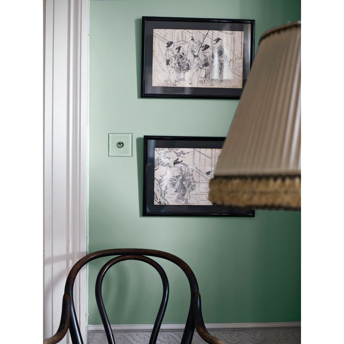 Black-framed ink drawings titled a dip in the lake displayed on a mint green wall for home decor use