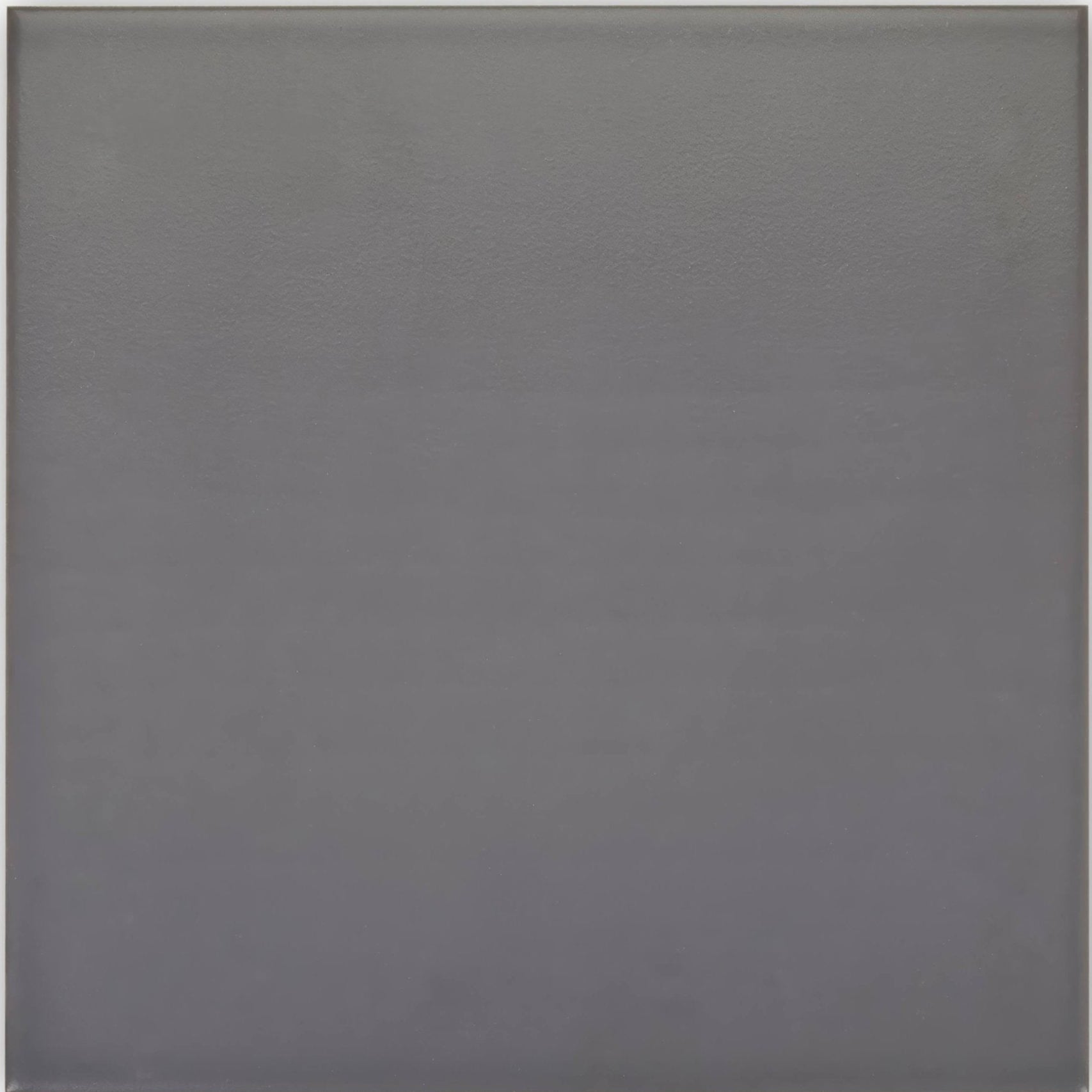 A matte gray abbey iron tile with a smooth uniform surface ideal for modern flooring or wall applications