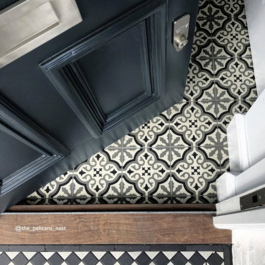 Dark blue paneled door with silver doorknob featuring abbey waverley patterned tile design