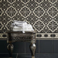 Stack of white and gray textured towels with fringed edges on ornate metal table for abbey waverley border tile