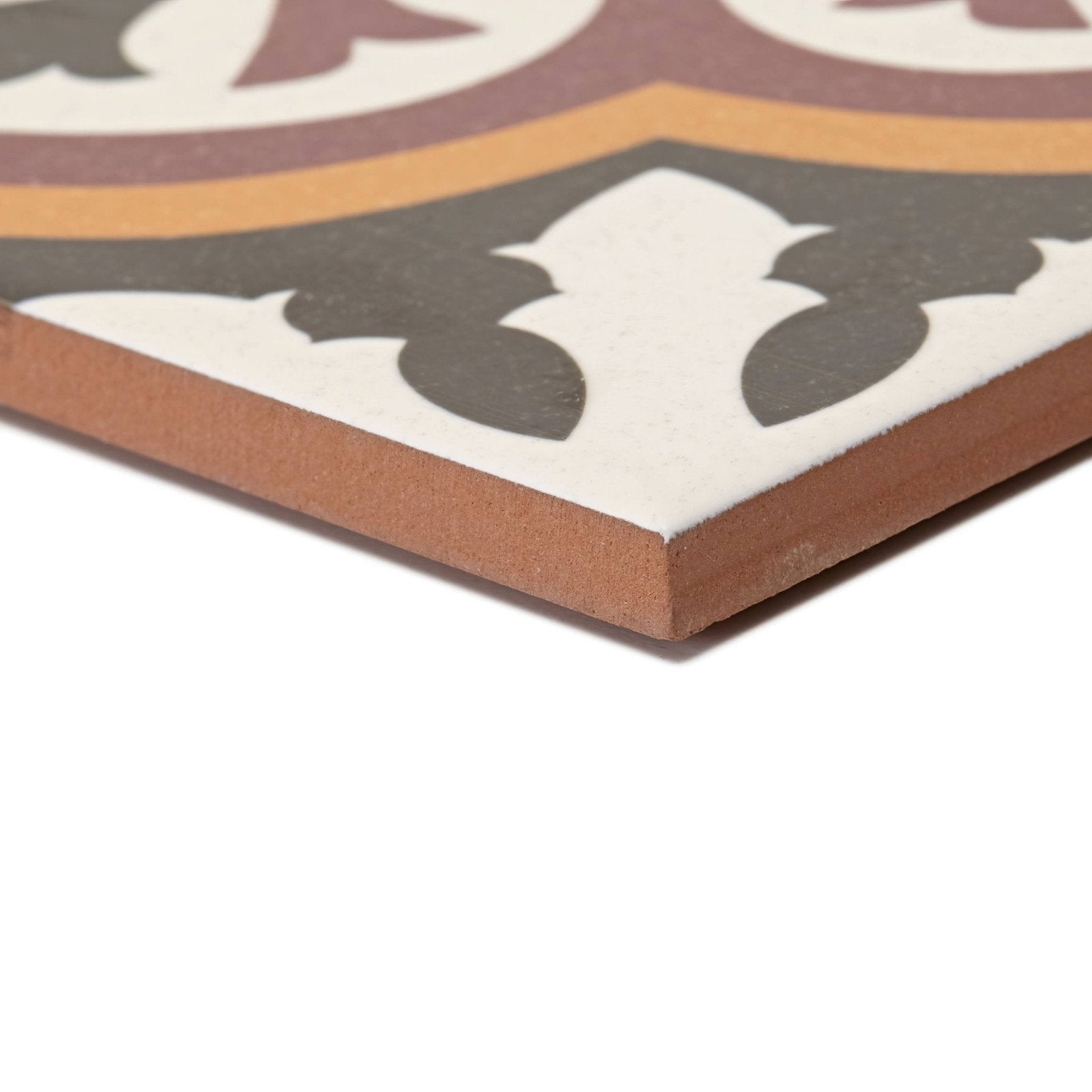 A square ceramic Abbey Whitby patterned tile with vintage maroon cream and mustard yellow designs on dark gray background