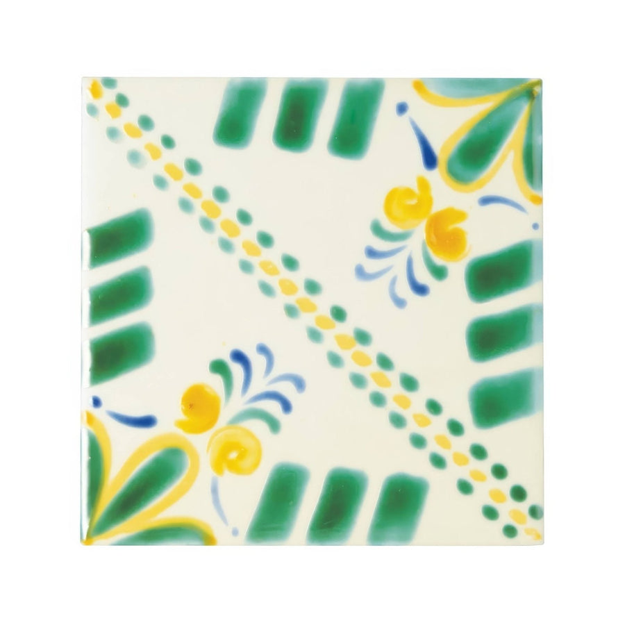 A square ceramic Acapulco Merida 10x10cm tile with hand-painted green yellow and blue floral motifs on off-white background