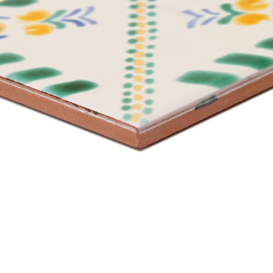 Acapulco Merida 10x10cm ceramic tile with cream surface and hand-painted green yellow and blue floral and dotted patterns