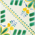 A vibrant acapulco merida 10x10cm ceramic tile with green yellow and blue hand-painted floral motifs on off-white background