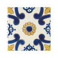 A ceramic tile acapulco ortiz 10x10cm with a cream background and intricate blue and yellow floral patterns