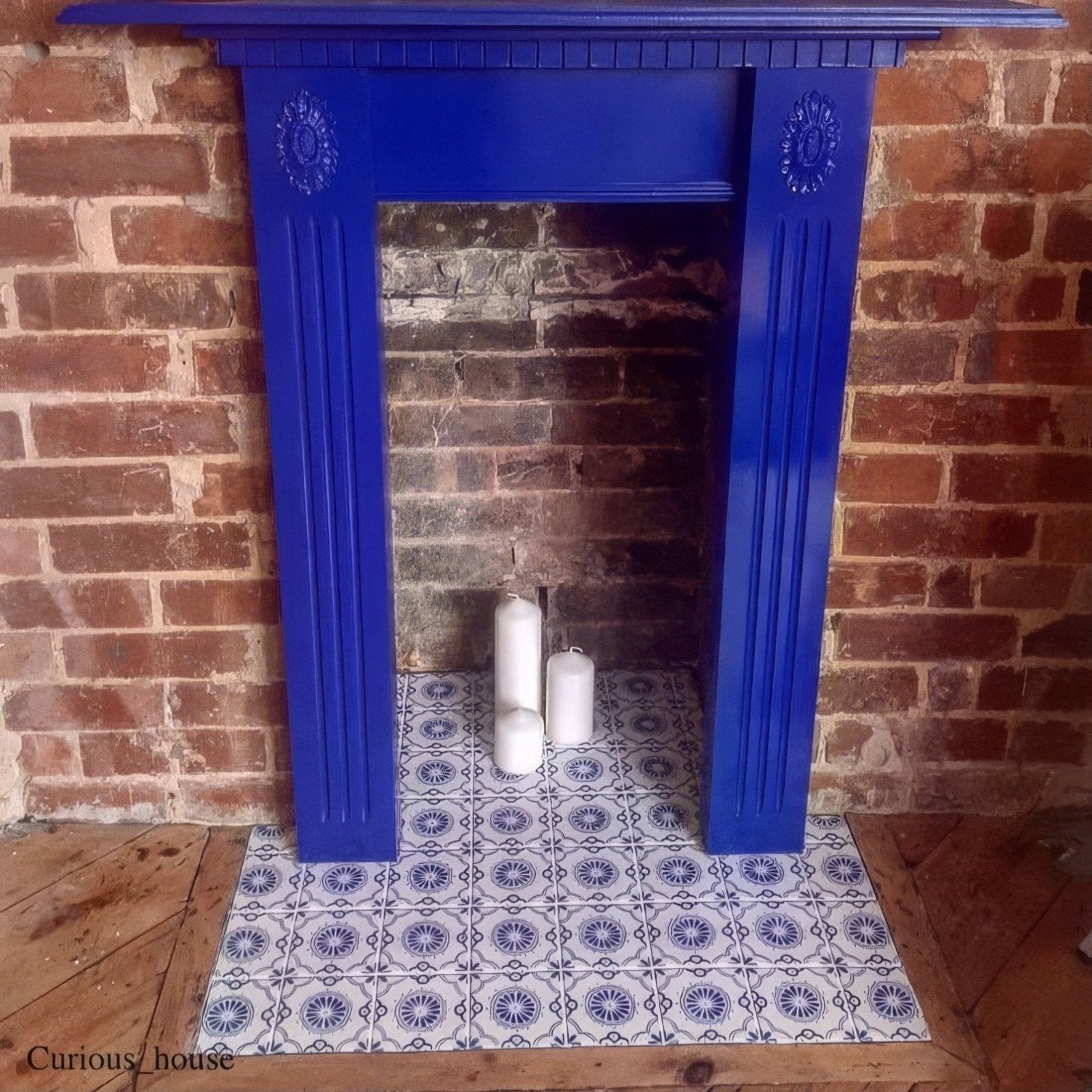 Vibrant blue painted 10x10cm Acapulco Salazar fireplace surround with decorative fluted columns and ornate crest details