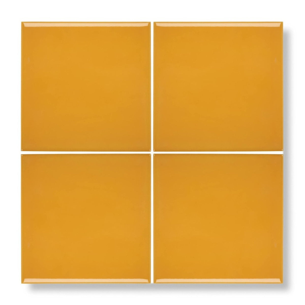 Four glossy mustard yellow square ceramic tiles arranged in a grid acapulco yellow city 10x10cm