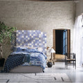 Blue and white patterned ceramic tile headboard from acapulco zenil 10x10cm collection for stylish wall decor