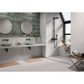 Modern bathroom with matte gray acorn pearl 60 x 60cm tiles and sleek black fixtures in minimalist design