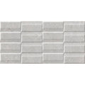 Gray rectangular ceramic tiles with subtle texture and raised horizontal ridges arranged in a staggered brick pattern acorn pearl exact decor