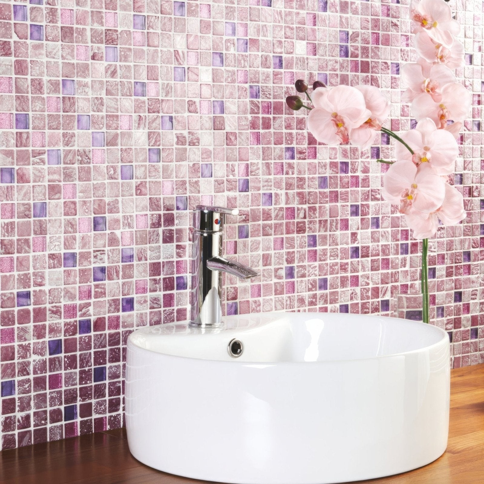 Actamira glass and stone mosaic shown behind a white ceramic vessel sink with a chrome tap