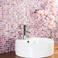 Actamira glass and stone mosaic shown behind a white ceramic vessel sink with a chrome tap