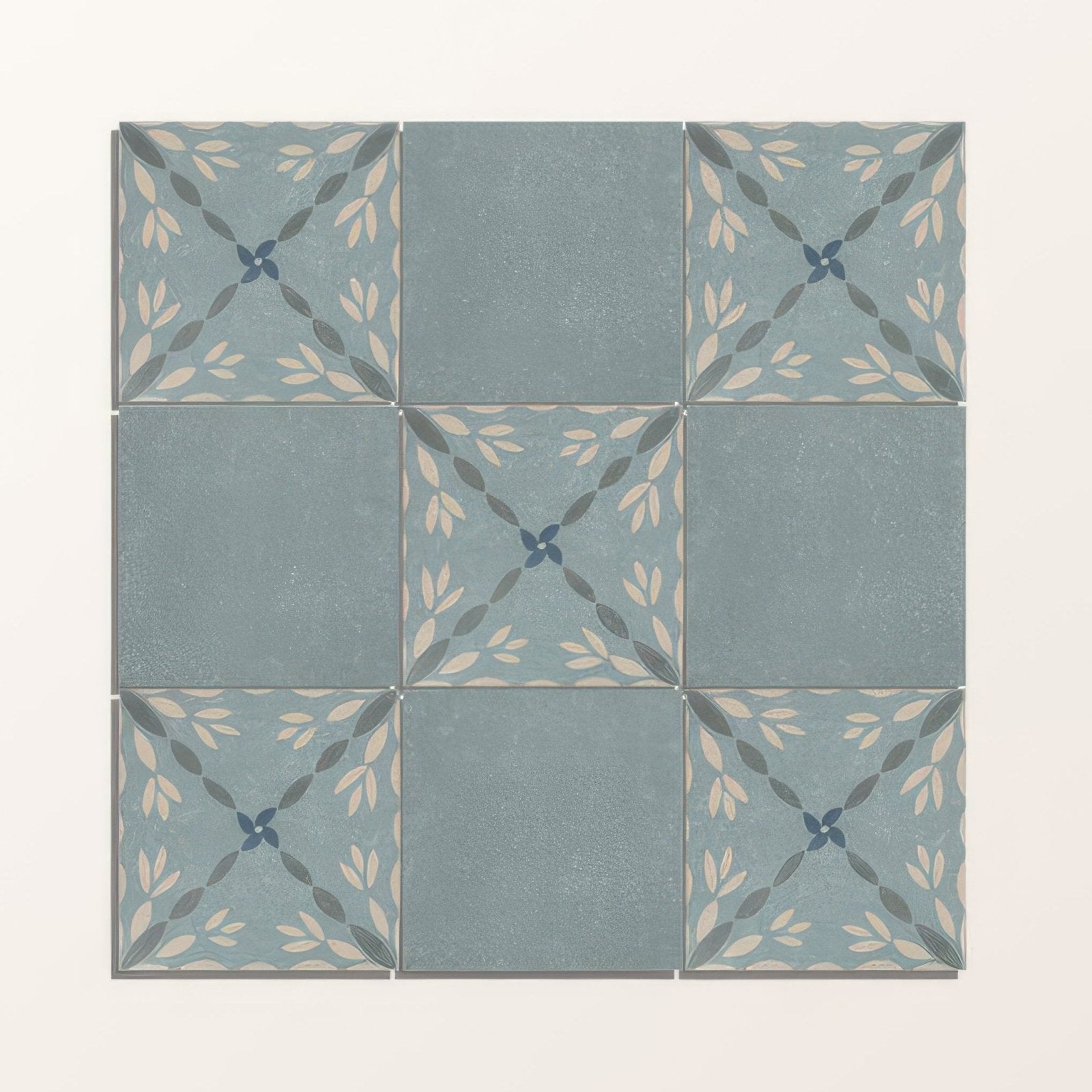 Set of nine adventuras blue field porcelain tiles in muted blue gray with elegant leaf patterns in cream and dark green
