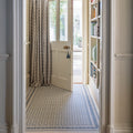 Hallway with adventuras malla blue porcelain tile floor featuring blue and white geometric patterned design