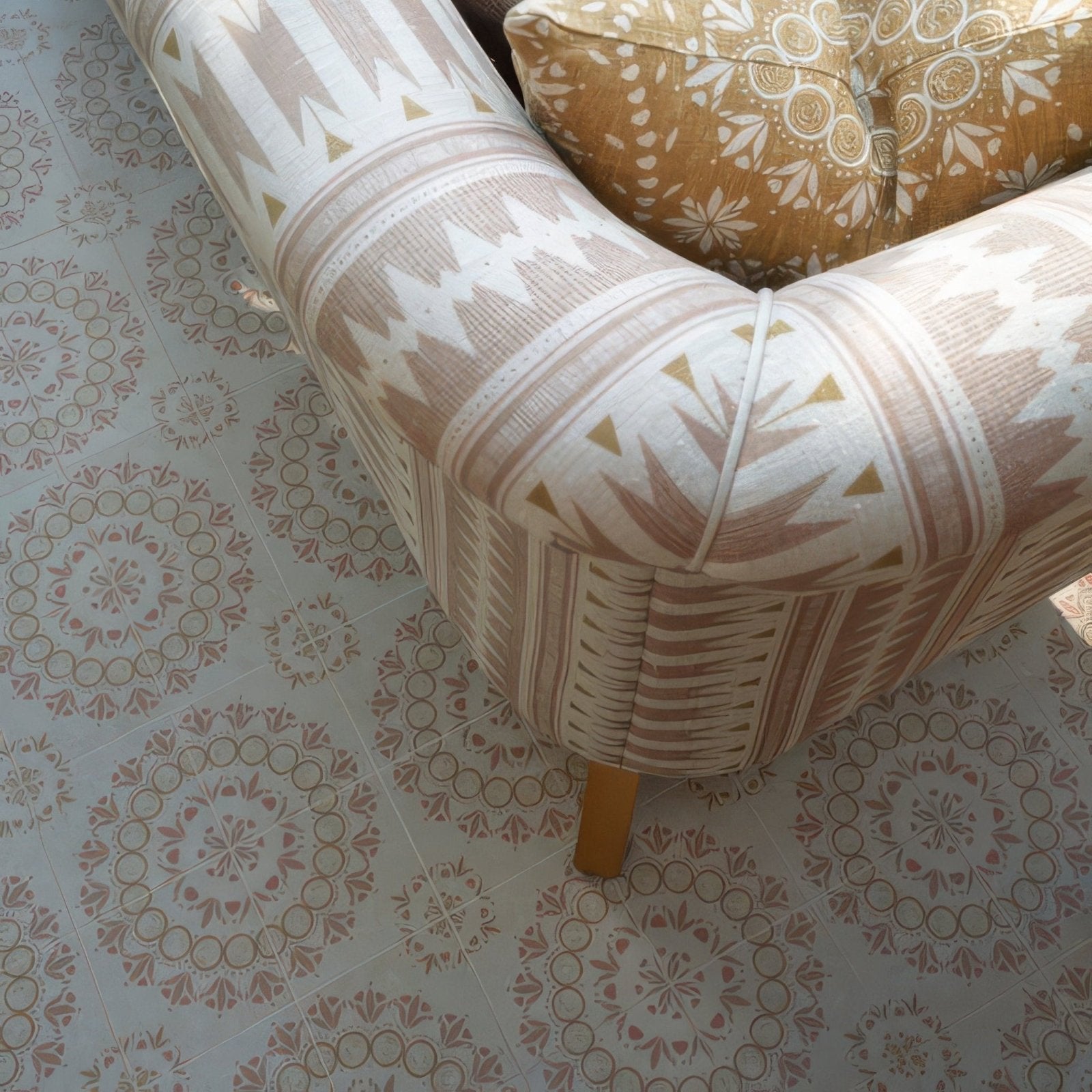 A beige and white patterned armchair with geometric designs tufted backrest and wooden legs in adventuras palma terracotta porcelain