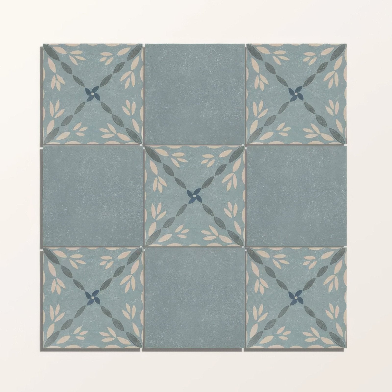 Adventuras porto blue porcelain square ceramic tiles with muted blue-gray base and cream dark green leaf patterns