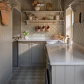 White farmhouse-style Adventuras Porto Olive porcelain sink with brass faucet and matching countertop in kitchen setting